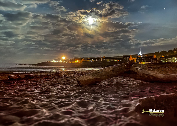 Clock tower in stonehaven from the beach at midnight